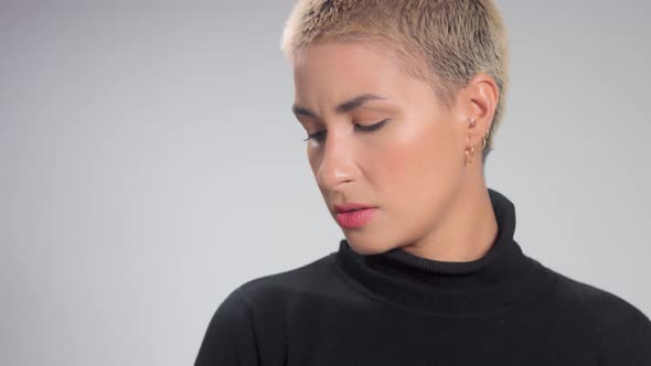 Blonde with Short Haircut in Studio Poses for Camera on Grey Ideal Skin