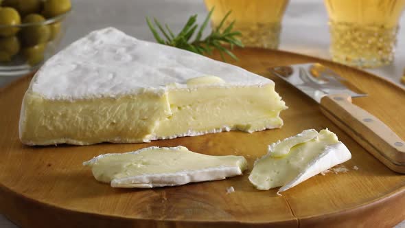 Pieces of fresh French brie cheese on a cutting board  
