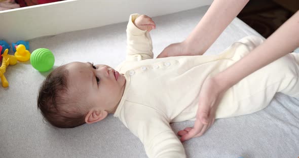 Mother Massaging Little Baby 