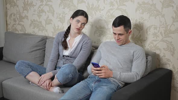 Husband Pays No Attention to His Wife and Keeping Play Game on Smartphone