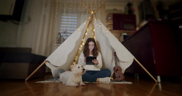 Woman Sit on the Floor with the Dog Jack Russell and Use Tablet