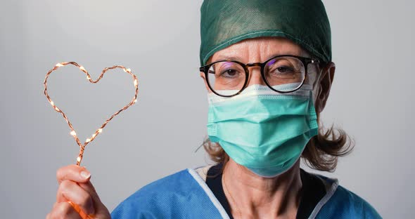 Doctor Woman is Holding Heart Symbol in Hand