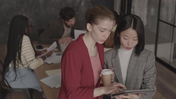 Multiethnic Female Colleagues Talking in Office / Videohive