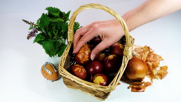 Naturally colored Easter eggs with onion skin and dried flowers. Eggs in the basket