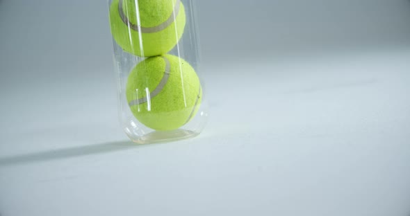 Tube of tennis balls against white background 4k