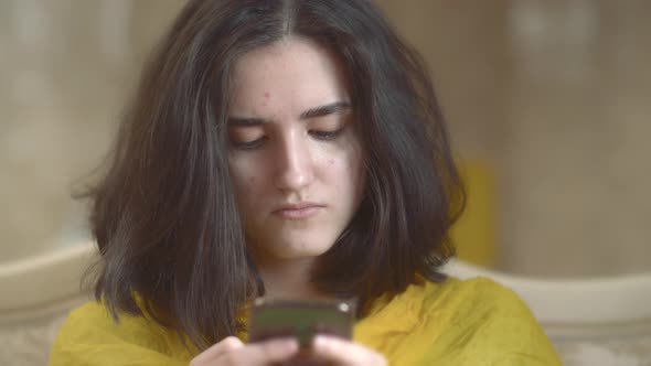 Portrait of Young Brunette Teenager with Mobile Phone Closeup