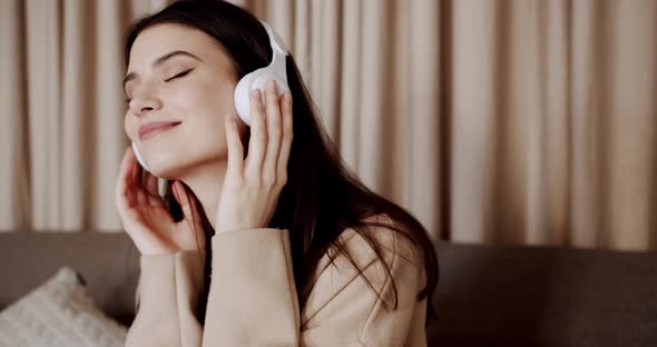 Mindful Young Happy Woman and Smile with Wearing White Wireless Headphones