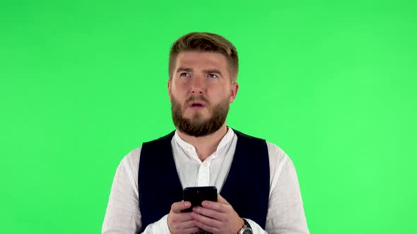 Tired Man Texting on His Phone on Green Screen