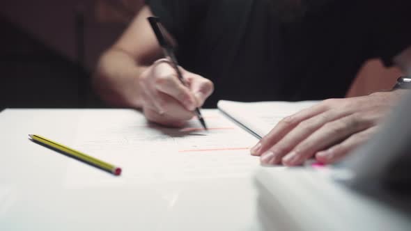 Man Studying And Underlining Important Text On The Reviewer Using Ballpen. - close up