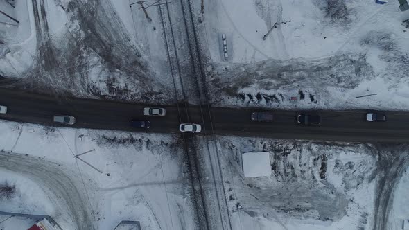 Top down aerial view of cars drive through the railroad crossing 09