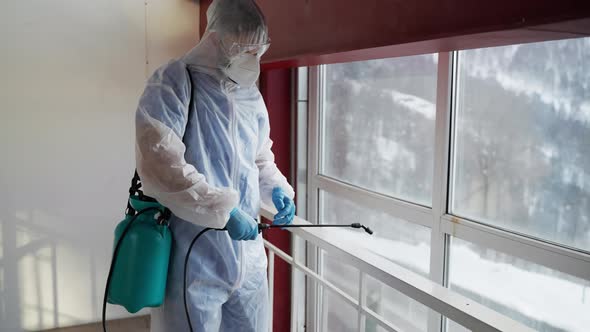 Worker Sanitizing Premises Using Sprayer