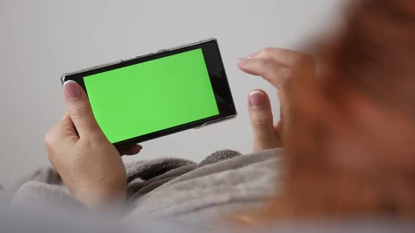 Slow motion of  redhead woman relaxing with  chroma key greenscreen tablet 1080p FullHD footage - Fe