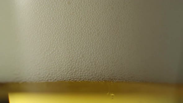 Pouring light beer into glass. Closeup view