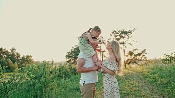 Young Married Couple with Cute Girl Spend Time Together Outdoors 