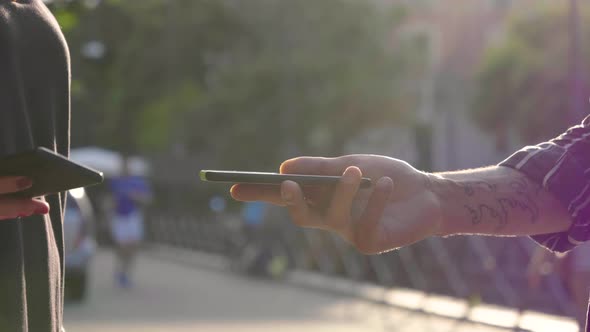 Slow motion shot of hands with smartphones in city