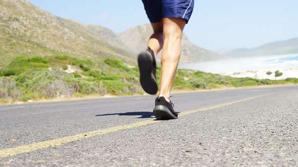 Triathlete man jogging in the countryside road