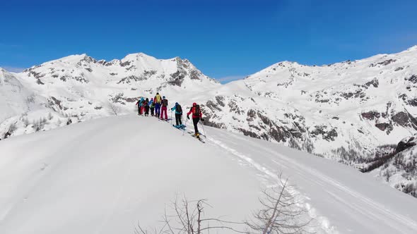 Group of ski touring on skin uphill in a line. Ski touring in big mountains