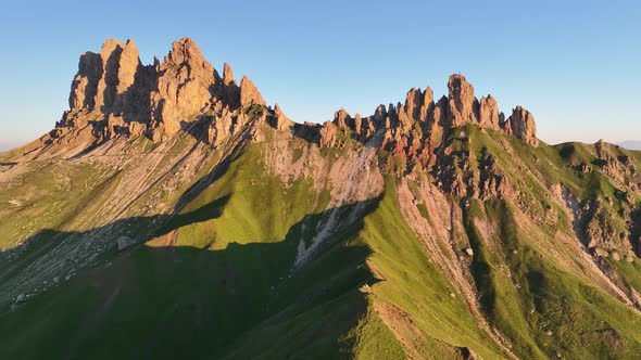 Dolomites mountains peaks with a hiking path on a summer sunrise