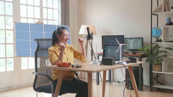 Asian Woman Being Happy Succeed Testing The Wind Turbine While Working With Laptop
