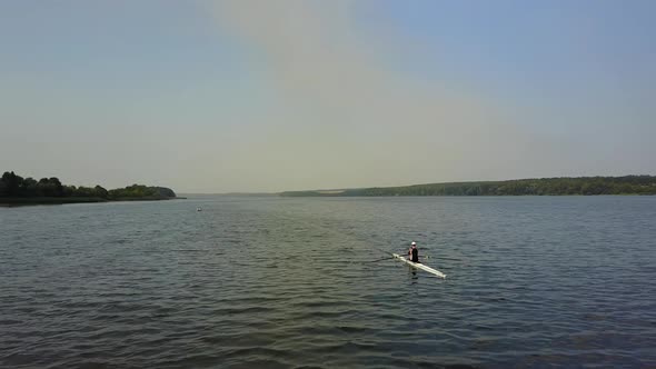 Training Athlete In Kayak. Training of small sportsmen rowers on a kayak on the river