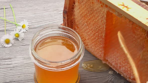 A Wooden Stick Helps to Get Cut Off Honeycombs in the Wooden Frame