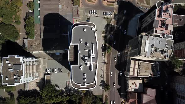 Aerial City View with Crossroads and Roads, Houses, Buildings, and Parking Lots.