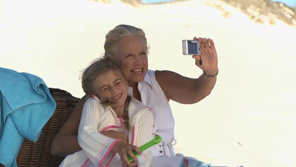 MS OF A GRANDMOTHER TAKING PICTURES WITH HER GRANDDAUGHTER