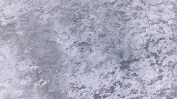 Aerial View of the Ice White Sea with Cracks