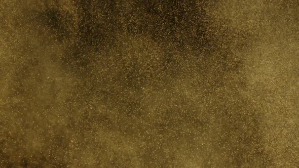 Burst of Flying Gold Dust Slow Motion Isolated on Black Backdrop