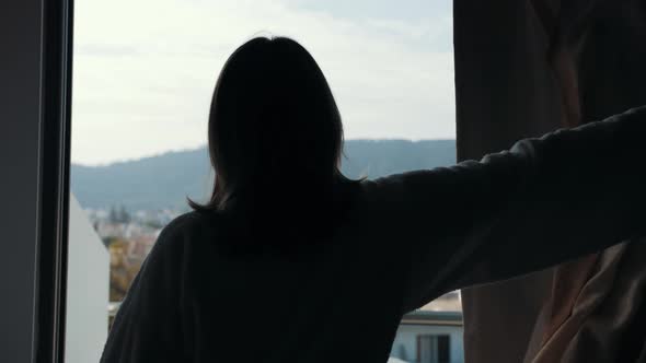 Woman Opening Curtains in Hotel Room Going Out on the Balcony and Enjoying View From Terrace
