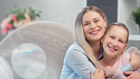 Happy Young Mother and Teen Daughter Laughing Having Positive Emotion Feeling Love