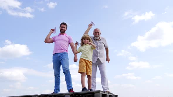 Happy Family of Boy Child with Father and Grandfather Hold Paper Planes Skyhigh Leisure