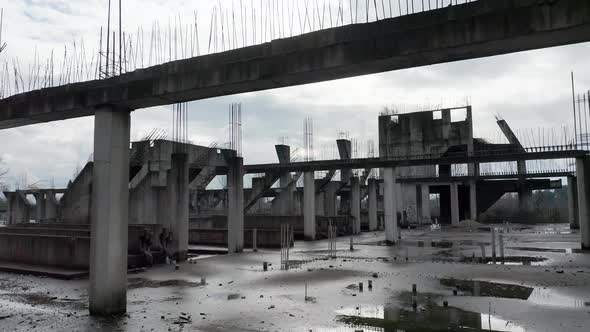 Concrete columns, girders and beams reinforced with steel bars on abandoned construction site