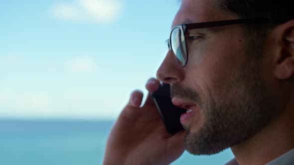 Smiling Businessman Talking Smartphone in Office Closeup