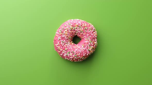 Sweet Doughnut with Pink Glaze Pastry Topping Isolated on Green