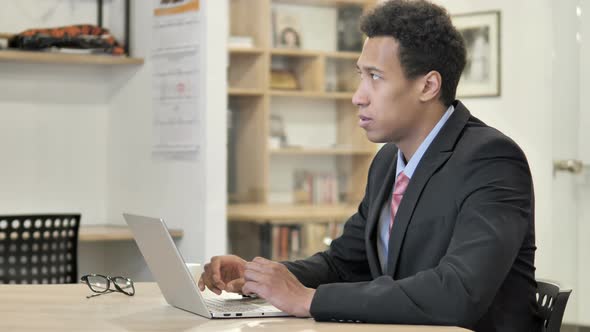 African Businessman Working On Laptop