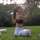 Side View of Young Woman Practicing Yoga Sitting Under a Tree.Wellness Concept - VideoHive Item for Sale