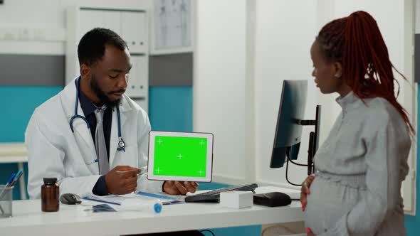 Health Specialist Showing Horizontal Greenscreen on Tablet