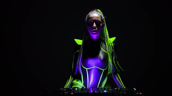 Front View Futuristic Woman with Fluorescent Makeup Singing Dancing Bending at DJ Set As Live Camera