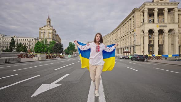 Woman Lifts Ukrainian Flag Running on Main Street of Kyiv