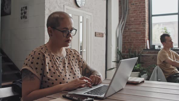 Young Woman Using Computer in Coworking