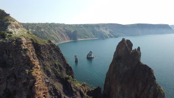 Aerial View From Above on Calm Azure Sea and Volcanic Rocky Shores