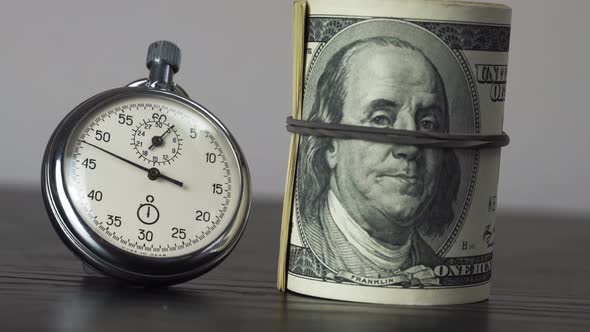 Dollars and stopwatch. Business concept of lost time and failed investments