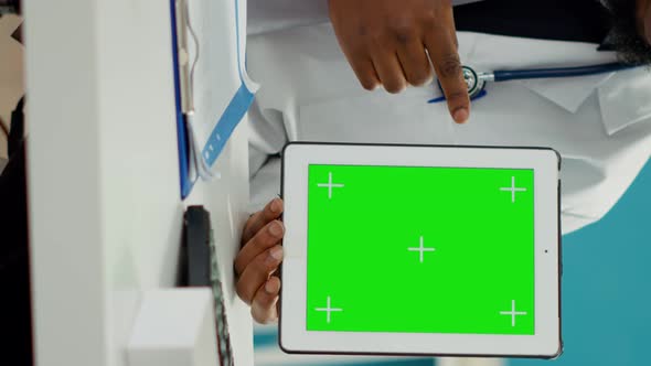 Vertical Video Male Obstetrician Using Greenscreen Template on Tablet Display