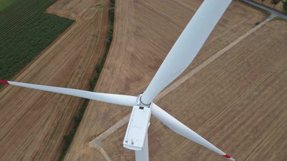 Windmill Turbine in the Field at Summer Day
