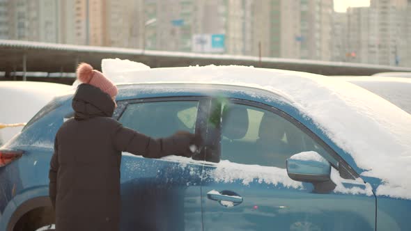 Scraping Ice. Scratching Ice From Car Window In Winter. Brushing Snow And Ice From Car Glass.