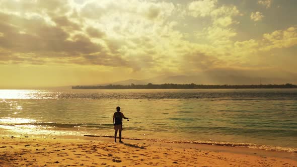 Man fisherman on paradise shore beach wildlife by transparent lagoon with white sand background of G