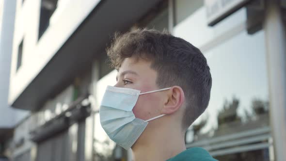 Calm young man in a protective medical mask close-up