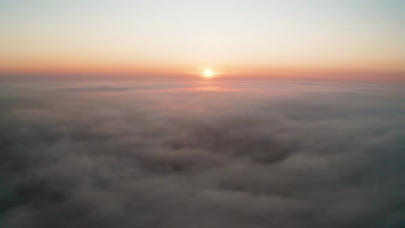 Aerial video over а morning calm sea with low clouds