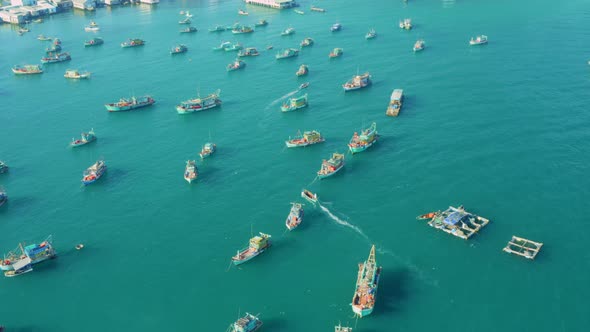Drone view of a fishing boat are sailing on the sea, in the middle of hundred boats are nailing in t